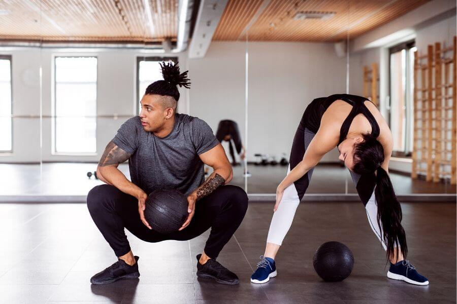 Two people working out together in a private studio gym